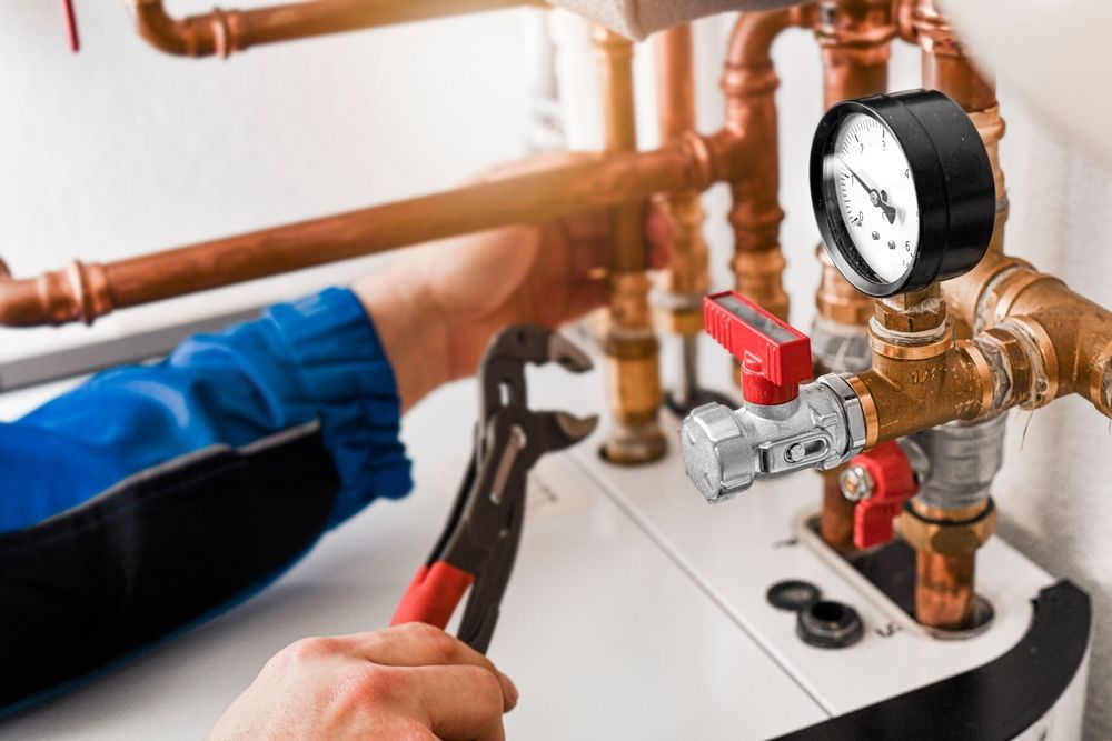 Technician servicing a pump system and pressure gauge
