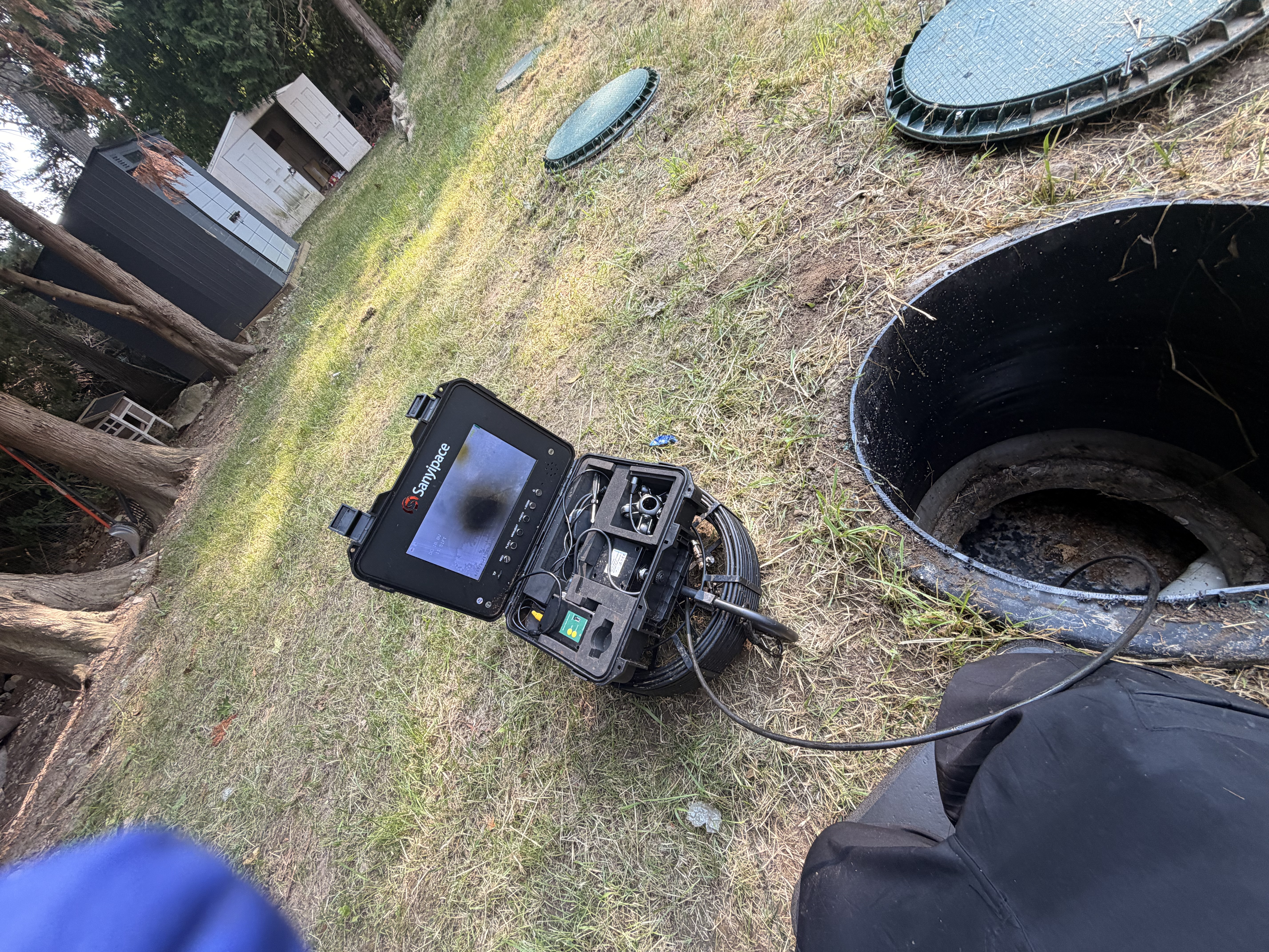 Technician viewing a live sewer camera inspection